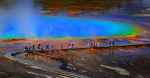 Tourists at Grand Prismatic Spring in Yellowstone National Park. Photo: iStock