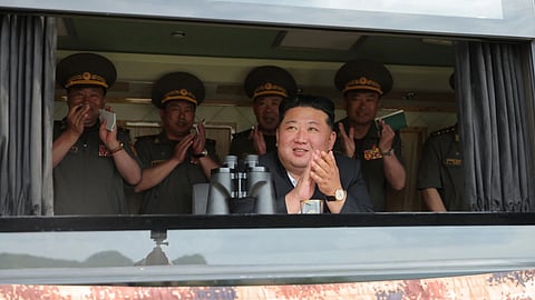 Kim Jong Un, center, observes the weapon tests at an undisclosed location, North Korea