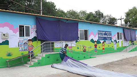 Newly constructed Anganwadi center building has been used as a polling booth for Assembly elections near Sowripalayam in Coimbatore, the election department yet to clean the school campuses and remove posters from the walls.