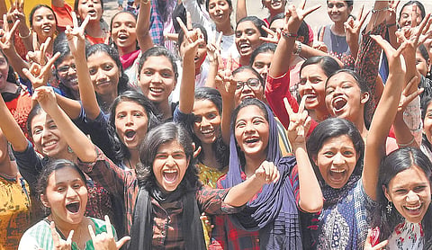 Students celebrating their success in the Odisha Plus-II exam result