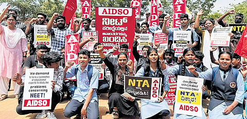 AIDSO members protest demanding the resignation of Union Education Minister Dharmendra Pradhan over the alleged irregularities in NEET-UG, at Freedom Park, Bengaluru, on Wednesday