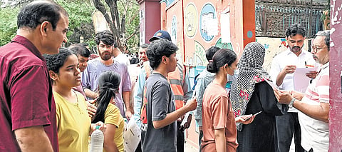 Candidates undergo security screening before entering exam centre 