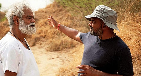 Sanjay Mishra with director Panda while shooting for Kadvi Hawa