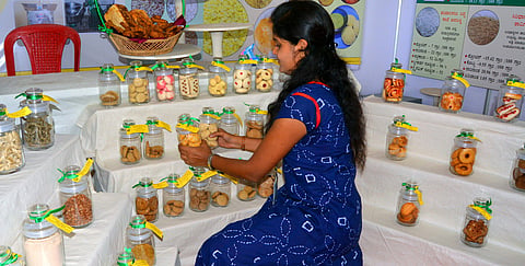 A girl selling millet cookies and other value-added millet products at Krishi Mela