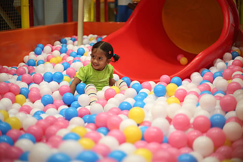 A child in the ball pen at Play2Grow