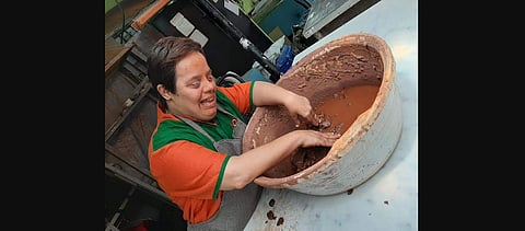A volunteer making Ganesha idol