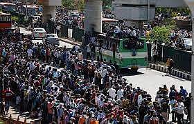 Migrant workers stranded at the bus stop