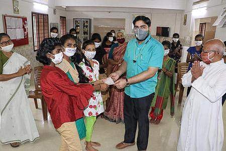 Children contribute to CMDRF by handing over a cheque to the District Collector on Friday