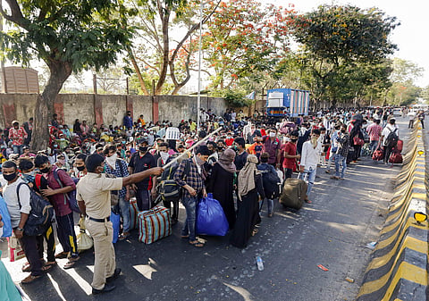 Migrants wait outside Mumbai's Chhatrapati Shivaji Terminus for a special train (Pic: PTI)