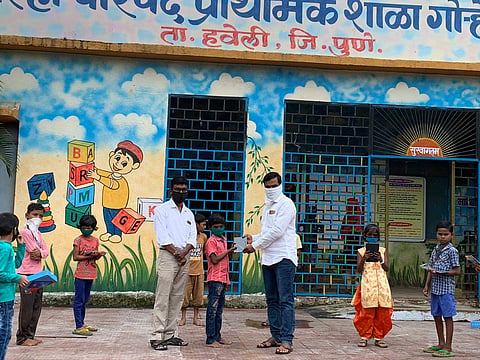 Students being given tablets at school
