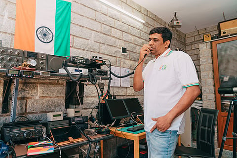 Madhu Prasad operating a  wireless radio to communicate with people