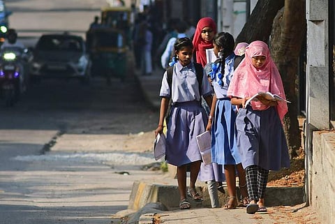 Student wearing hijab on the way to write the SSLC exam in Karnataka | Pic: EPS