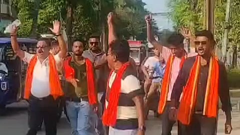 গেরুয়া ও লাল উত্তরীয় পরা একদল ব্যক্তির রাস্তায় হাত তুলে স্লোগান দেওয়ার দৃশ্য।