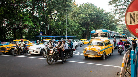 Vehicles stopped at a pedestrian crossing in Kolkata
