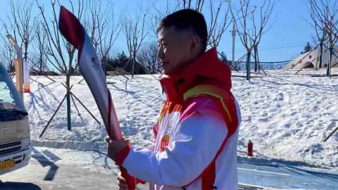 China Handed Beijing Winter Olympics Torch to soldier 