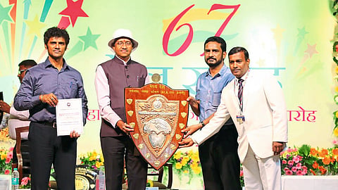 accepting the award Railway Station Master R. K. Kuthar

