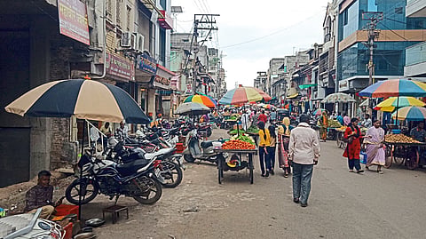 A street lined with hawkers on busy Agra Road