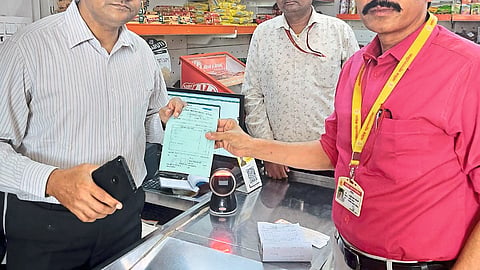 Sanitation Superintendent collecting fine from shopkeepers for plastic usage.