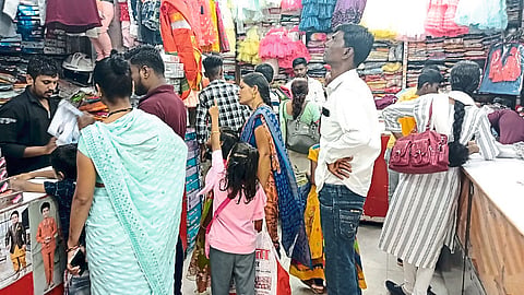 Crowd in the shop to buy clothes.