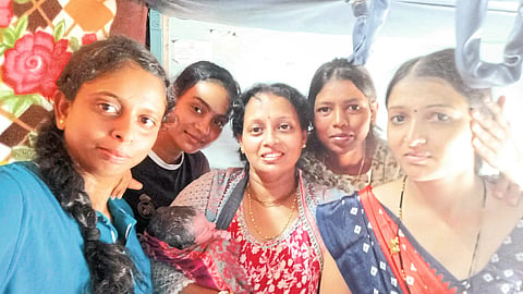 Sapna Patil (Deore) with baby. Traveling women helping neighbors.