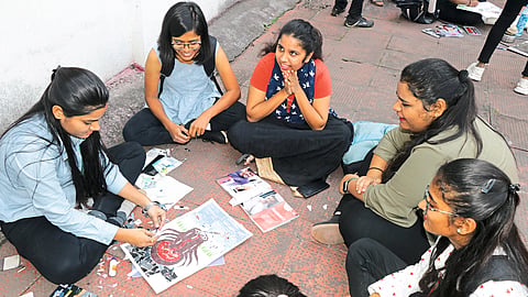A female student engrossed in collage work at the 'Sakal-yin' art festival on Friday in the premises of MSW College of MVIPR on Gangapur Road.