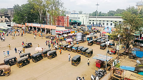  vehicles standing awkwardly at the railway station.