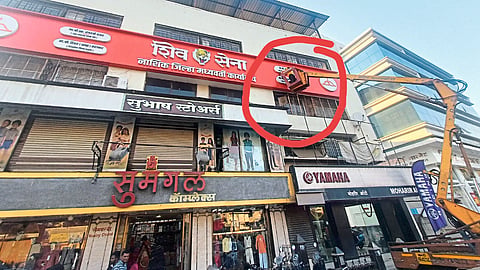 Removing the name from the plaque on the Shiv Sena Bhavan with the help of a crane.