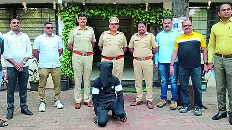 The arrested suspect and senior police inspector Anil Shinde, inspector Ganesh Nhayde and police personnel.