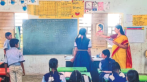 Ashima Mittal studying from the students of Zilla Parishad school here.