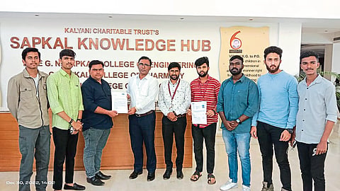 Kalyani Charitable Trust's Sapkal Knowledge Hub, Engineering College Principal Dr. S. B. Bagal Yin's Divisional Officer Ganesh Jagdale while handing over the election brochure.