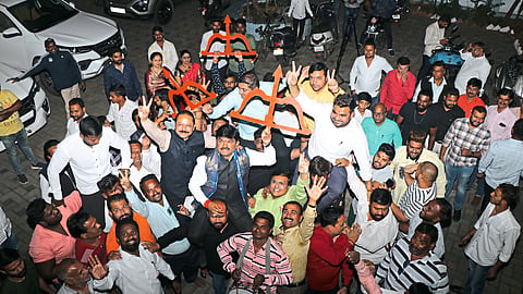 MP Hemant Godse, Ajay Boraste, Pra Veen Tidme along with MP Hemant Godse cheering while waving the saffron flag.