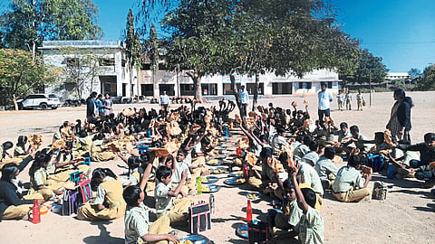 Students showing papad with nutritional food.