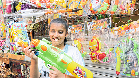 A little girl who was shocked to see the new type of sprayer that was sold in the market.