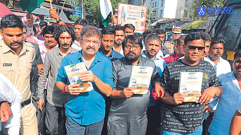 Former minister Jitendra Awad protesting with the constitution in his hands on Saturday regarding the Vedokta and Puranokta dispute at Srikalaram temple.

