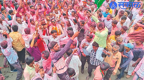 Officials and activists cheering in the procession for the election victory.

