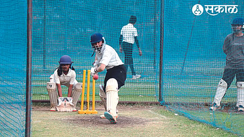 Girl players practicing cricket.