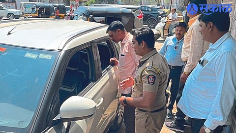 A team of the city police station inspecting a car after its window was broken and stolen
