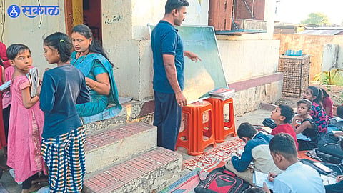 API Mahendra Waghmare and Sunita Waghmare giving education and culture lessons to children in the premises of their government residence.
