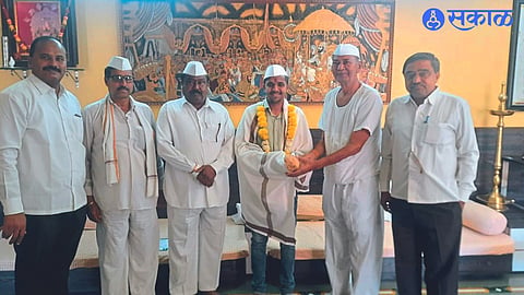 Ambadas Bankar, Zilla Parishad member Sanjay Bankar while felicitating Vinay Jadhav.