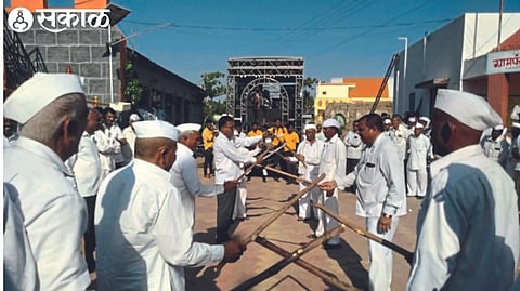 Senior citizens and villagers dancing Tipri on traditional sambal instruments at Shivaji Chowk.
