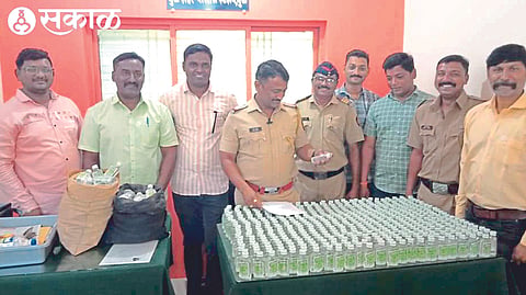 Inspector Anand Kokre inspecting the liquor seized by the city police.

