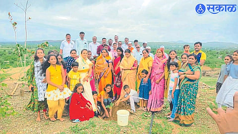 A child planting seedballs after seed samskara by Akhil Bharatiya Shri Swami Samarth Sevamarga. Neighbor servants.
