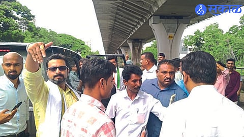 Amol Kolhe and office bearers looking at the building from the guard stationed in front of the NCP building
