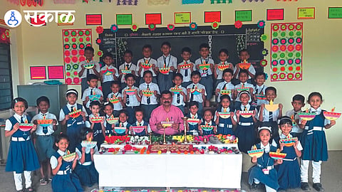 Teacher Gorakh Sanap and students performing Deep Puja at Vainteya Primary School 
