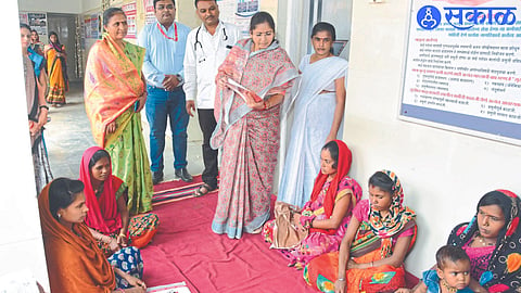 State Women's Commission member Deepika Chavan, medical officer next to her while discussing with a female patient who came to the primary health center.
