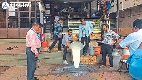 Vendor pouring adulterated milk after inspection by authorities.

