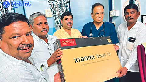 While handing over the LED Smart TV to the school teachers,  Dr. Narayan Sonawane.