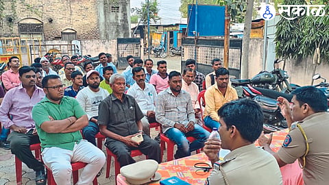 Upper Superintendent of Police Ramesh Chopde speaking at a meeting of office bearers of Durga Utsav Mandal. Police inspector Uddhav Dhamale on the dais.
