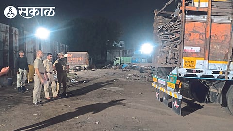 A senior police officer inspects an illegal scrap business on the Mumbai-Agra highway.