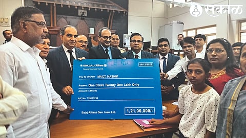 Officials handing over a settlement check to the heirs of the accident victims after a hearing at the National Lok Adalat on Saturday.